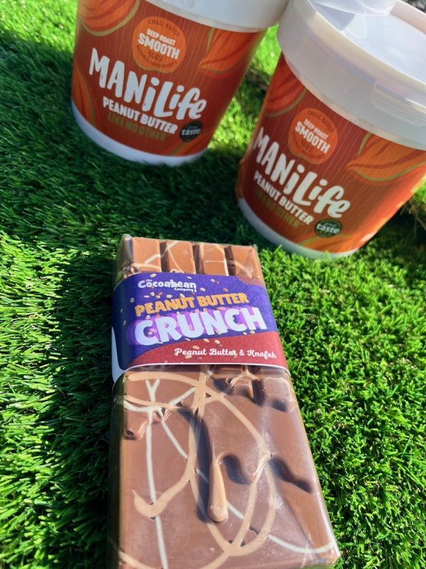 peanut butter crunch with mani life peanut butter tubs on grass