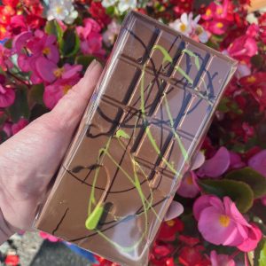 pistachio brown bar behind held over pink flower backdrop