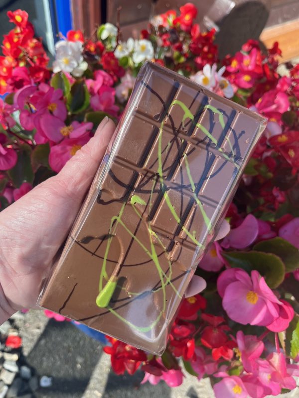 pistachio brown bar behind held over pink flower backdrop