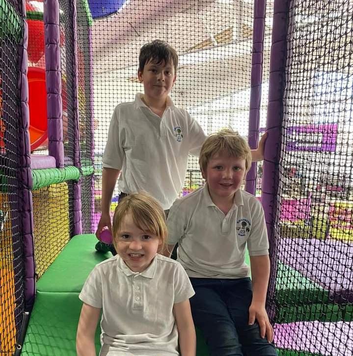three school kids in the soft play