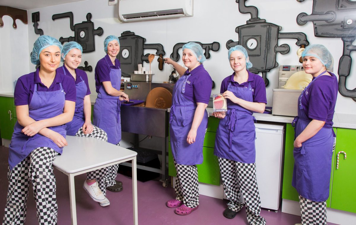 cocoabean staff in purple uniforms and standing in workshop